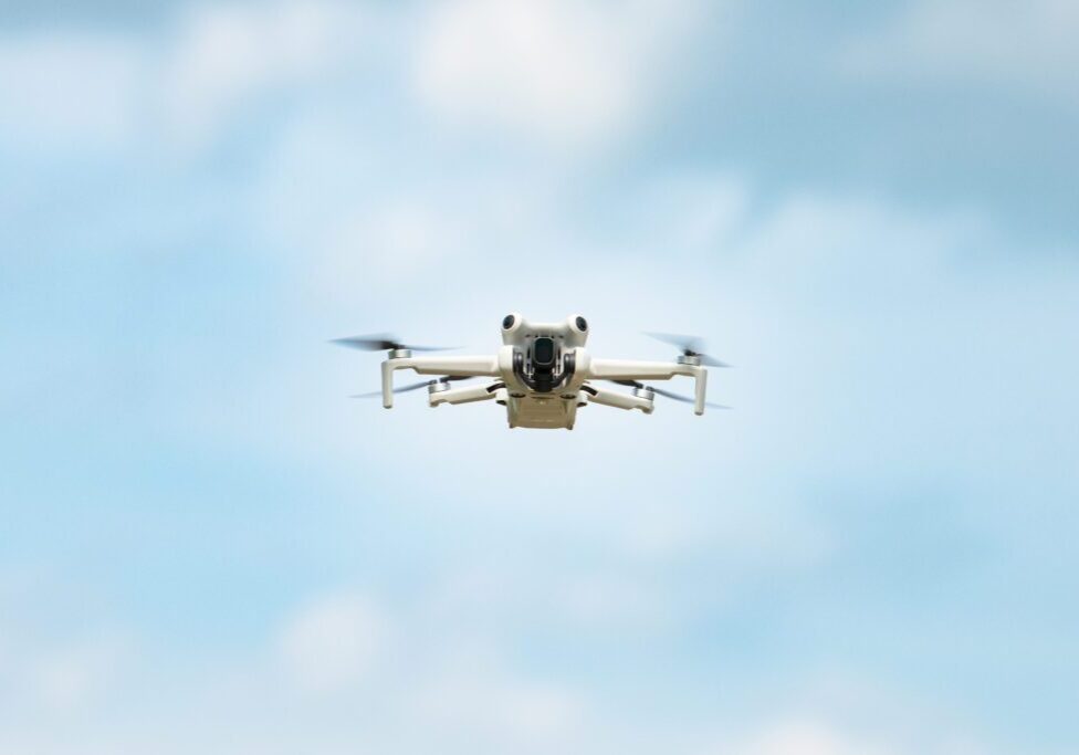 Drone flying in clear blue sky